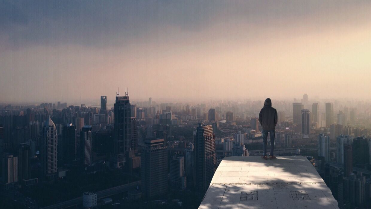 A man standing on the edge of a building